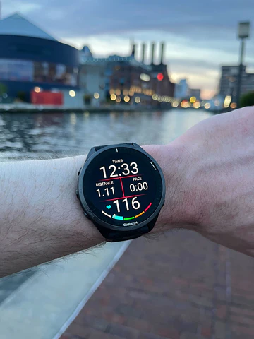 Garmin Forerunner 965 na nadgarstku, a w tle centrum Baltimore Warszawa